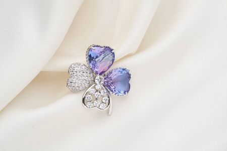 Silver brooch shaped like a flower, with small diamonds, isolated on white background. Women Accessoriesの写真素材