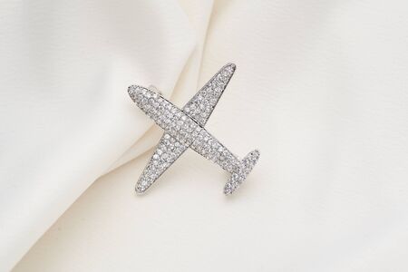 Silver brooch shaped like an airplane, with small diamonds, isolated on white background. Women Accessoriesの写真素材