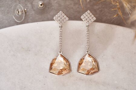 Earrings isolated, with white crystals and diamonds. Beautiful earrings on white background. Women accessoriesの写真素材