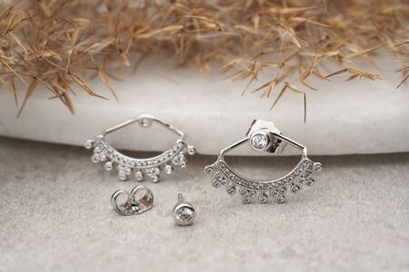 Earrings isolated, with white crystals and diamonds. Beautiful earrings on white background. Women accessories.の写真素材