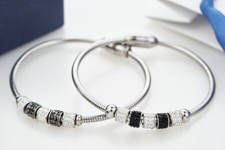 Close up shot of beautiful silver bracelets with crystals isolated on white. Magnet closure. Women Accessories.の写真素材