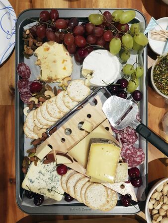 cheese platter with grapes and crackersの写真素材