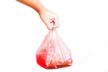 A picture of plastic bag with food and drinks inside on isolated white background. Plastic usage in Malaysia increase drastically and main cause of earth pollution.の写真素材