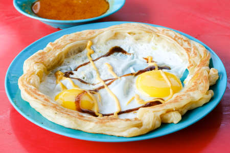 Selective focus picture of roti sarang burung serve on the table. Flatbread looks like bird nest...