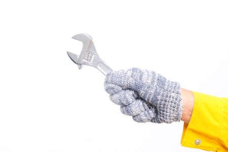 A picture of hand with glove holding wrench.の写真素材
