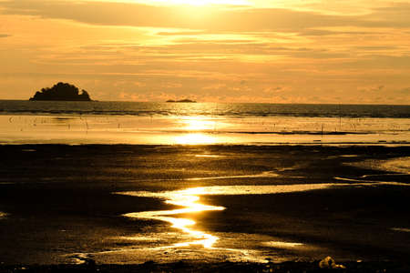 Follow the line sunset picture with low tide and sun reflection at Kuala Selangor. It is a home of seafood and seashell that attracts tourist to the place.の写真素材