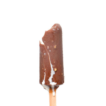 A picture of bitten coco bar ice cream with vanilla flavour flowing out on isolated white background.の写真素材