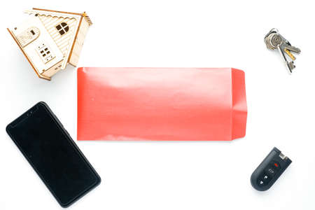 A flatlay picture of bribery gift concept using red envelope money, blank smartphone, remote car...