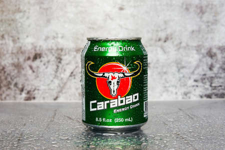 Cold carabao energy drink on stone table and rough wall