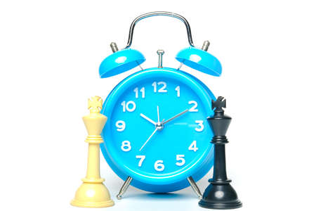 A picture of two chess kings with alarm clock on white background.  Time to choose your leader...