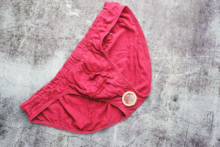 A picture of red underwear with condom on crack cement. Symbol for World AIDS Day and safe sex...