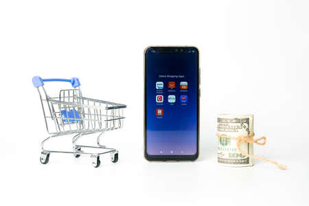 "Klang,Malaysia- Circa November, 2020: A picture of online shopping apps at smartphone with cart and fake cash insight."のeditorial素材