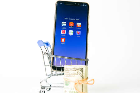 "Klang,Malaysia- Circa November, 2020: A picture of online shopping apps at smartphone with cart and fake cash insight."のeditorial素材