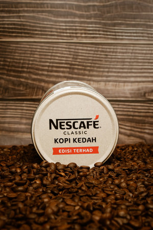 Limited edition Nescafe Classic Kopi Kedah canister lying on coffee beanのeditorial素材