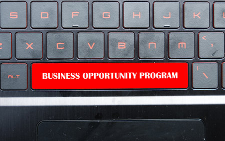 A picture of keyboard with the word BUSINESS OPPORTUNITY PROGRAM on space bar with dust insight. Business Opportunity Program help to bring up new entrepreneur in all industry.の写真素材