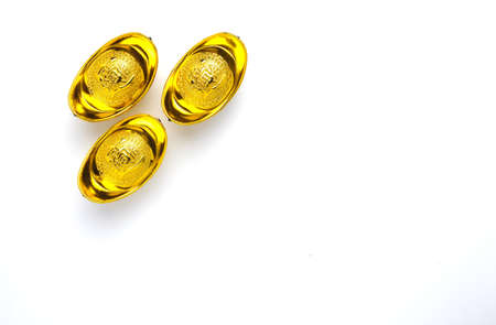 A picture of golden sychee or yuan bao with written word prosperity on isolated white background.