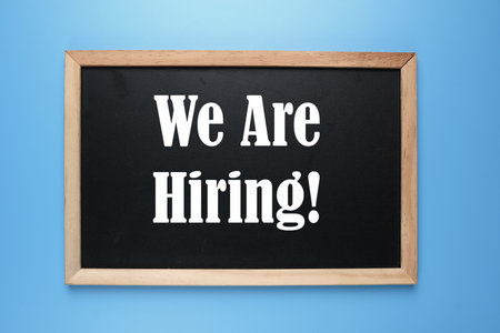 A picture of  blackboard written we are hiring on blue background.の写真素材