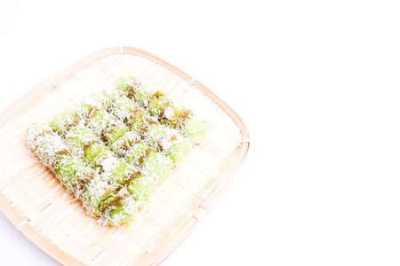 A picture of kue putu and putu bambu on the bamboo tray on white background