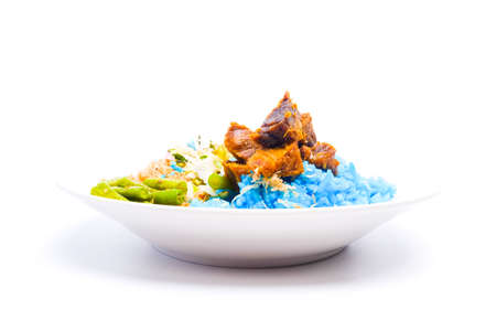 A picture of "nasi kerabu daging bakar" set on white background.Blue-coloured rice from petals of clitoria ternatea flowers ate with Malay salad and meat.の写真素材