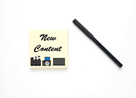 Magic pen with notepad written new content, illustration of clapperboard, camera and laptop. Content creator concept.の写真素材