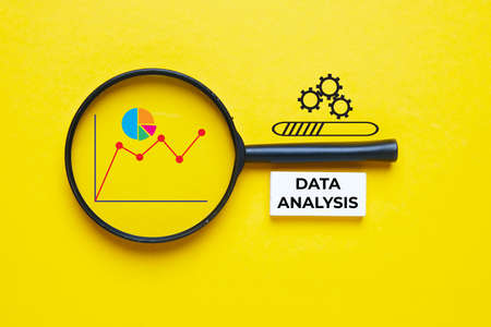 A picture of magnifying glass, graph, pie chart and data analysis word.の写真素材