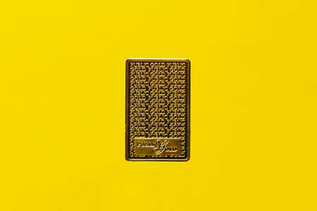 A picture of Public Gold engrave gold bar on yellow backgroundのeditorial素材