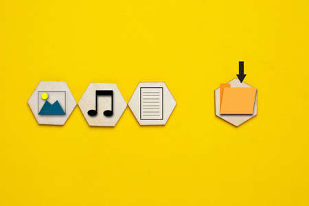 A picture of picture, music, document and save file symbol on yellow backgroundの写真素材