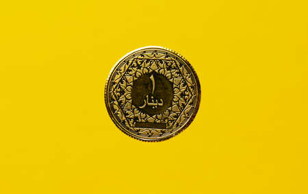 A picture of levitation of 1 dinar gold coin collection on yellow backgroundの写真素材
