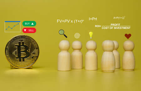 A picture of Bitcoin with selective focus peg dolls and financial formula for investment.の写真素材