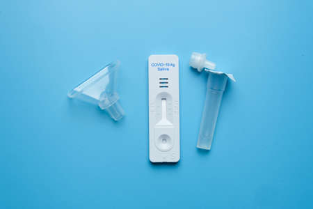 A picture set of Covid-19 saliva self test kit on the table. People are now encourage to self test before going outの写真素材