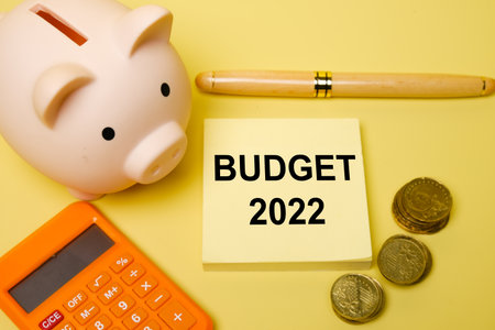 Selective focus of piggy bank and budget 2022 word with other item insight. Budget and planning for year 2022 concept.の写真素材