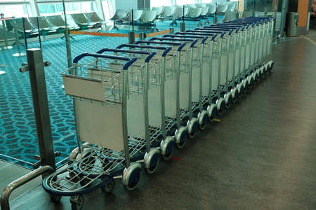 Selective focus of trolley in a row in the airport.