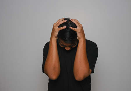 A picture of depress man. Depress and frustation of current situation. Covid impact on economy, society and psychology.の写真素材