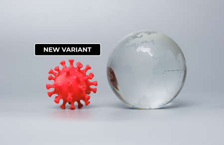 A picture of 3D printed coronavirus with glass globe and new variant word. New variant and mutation...