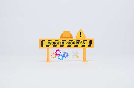 Selective focus of work in progress sign safety helmet, warning sign, gear and tools insight.の写真素材