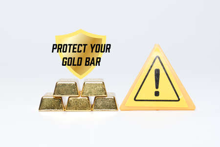 A picture of gold bar protection and insurance concept. Gold bar, warning sign, protect your gold bar word and shield.の写真素材