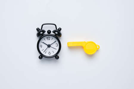 A picture of alarm clock and whistle on white background. Extra time conceptの写真素材