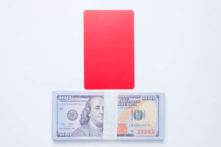 A picture of red card with fake cash on white background. Say no to match fixing concept.の写真素材