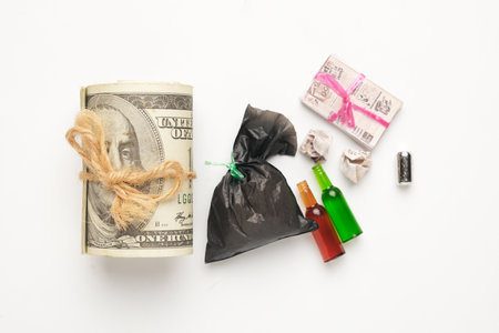 A flatlay picture of rubbish with fake cash. Rubbish dump business.の写真素材
