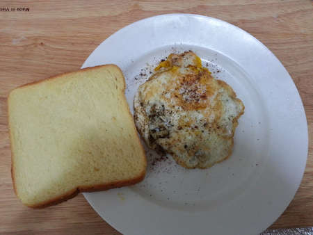 Fried egg with bread served in plate