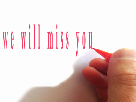 Hand writing We'll Miss You with red marker