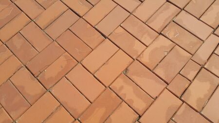 Closeup texture of red brick wall. A background of a weathered old exterior brick wall in the...