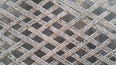 Closeup view of dried jute thread or ropes interwoven for making traditional old style bed called...