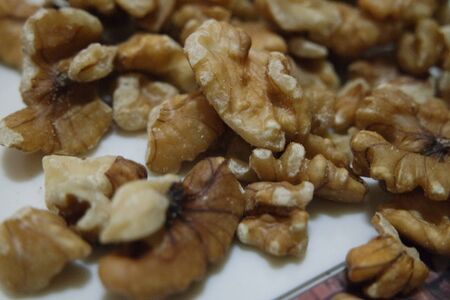 Close-up top view of peeled walnut on a white background. peeled walnut without shell ready to eat...