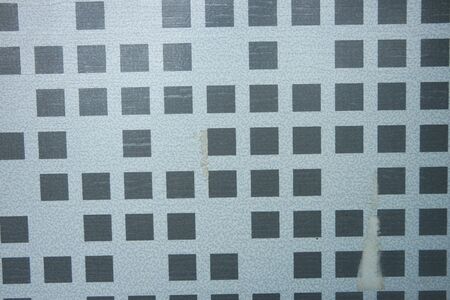 Closeup texture of black brick wall. A background of a weathered old exterior brick wall in the...