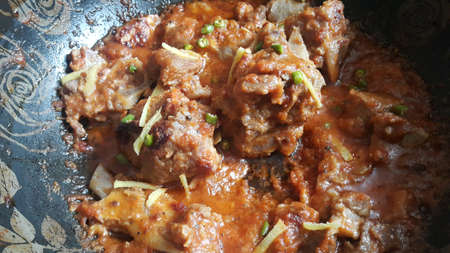 Meat, mutton or chicken curry dish in a bowl garnished with chilli and spices. Indian Pakistani...