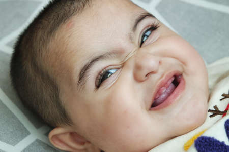 Baby girl with lovely face, big eyes and cute face gesture. Toddler baby making sweet activities
