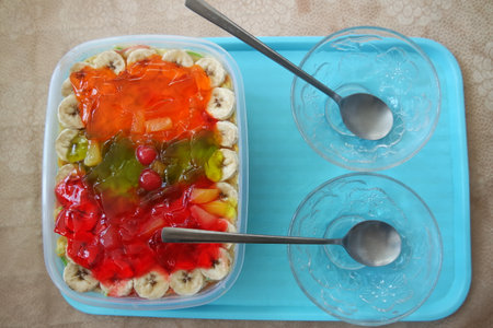 Creamy custard sweet dish with with different slices layered on surface. A top view of home made custard, a dairy products for dessert after meal.の写真素材