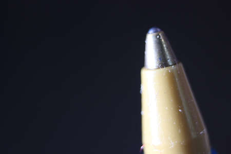 Macro photo of ballpoint pen tip with dark grey background. Extreme macro image of metal ballpoint pen on grey background.の写真素材