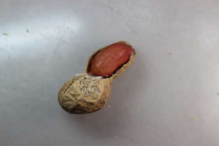 Unpeeled peanut with shells. Food background of peanutsの写真素材
